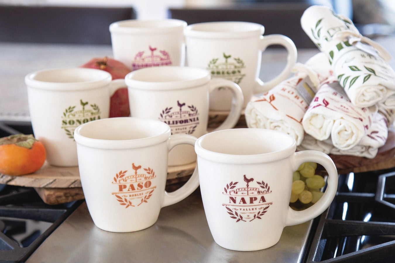 A variety of personalized ceramic mugs showcasing different designs, perfect for destination retailers. These custom ceramic mugs feature locations like Napa Valley and Sonoma, ideal for retail shelves and gift shops.