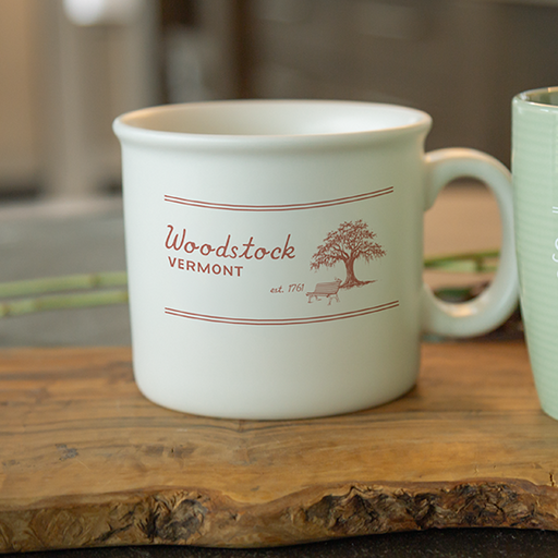 ceramic chunky mug on wooden surface with blurred background