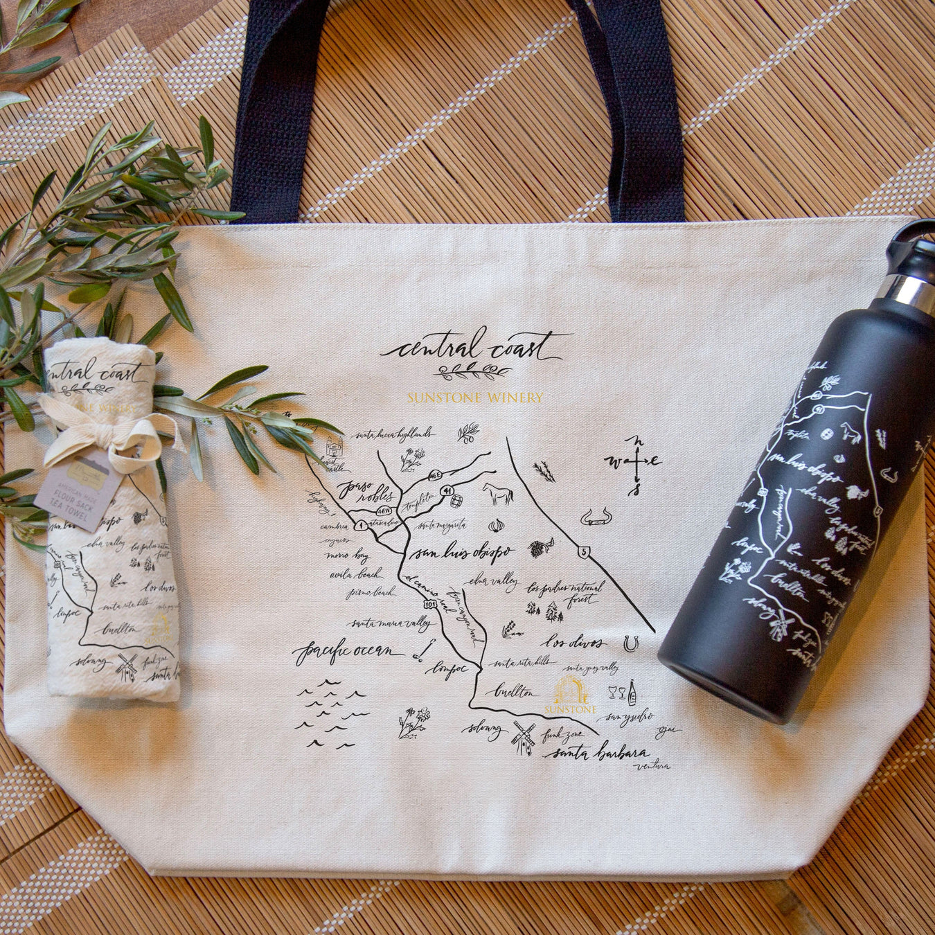 Heavyweight tote bag with map design, black water bottle on wood surface